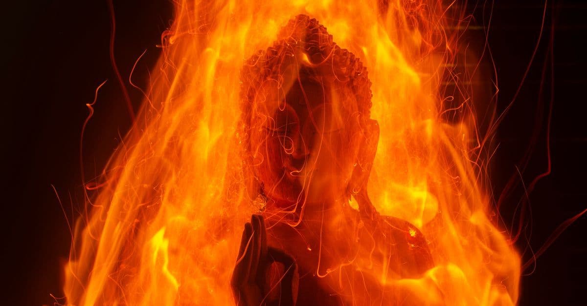 Vibrant depiction of a Buddha statue engulfed in artistic flames, symbolizing spirituality.