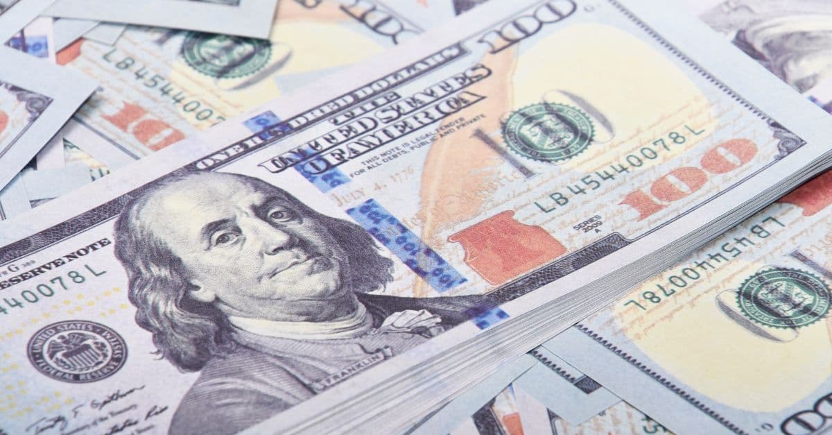Detailed close-up of United States 100 dollar bills emphasizing currency and finance.