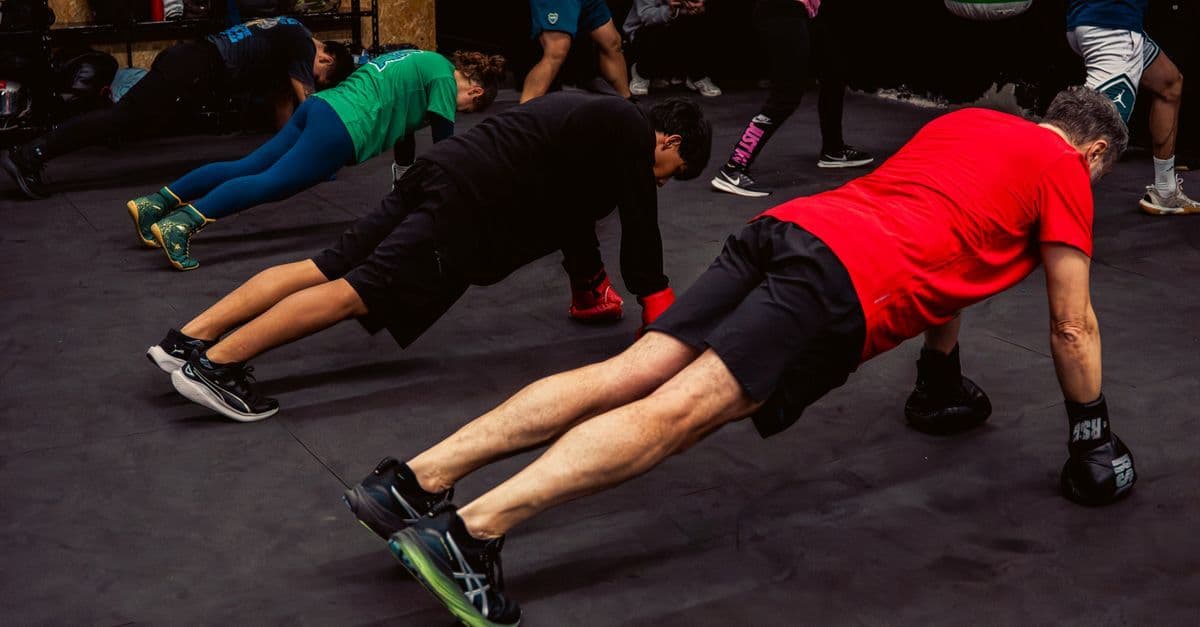 Adults engaging in intense group fitness exercise session indoors, Buenos Aires gym.