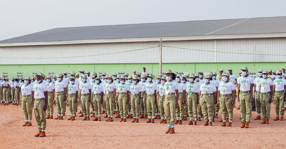 A large group of uniformed individuals standing in formation outdoors, illustrating discipline and unity.
